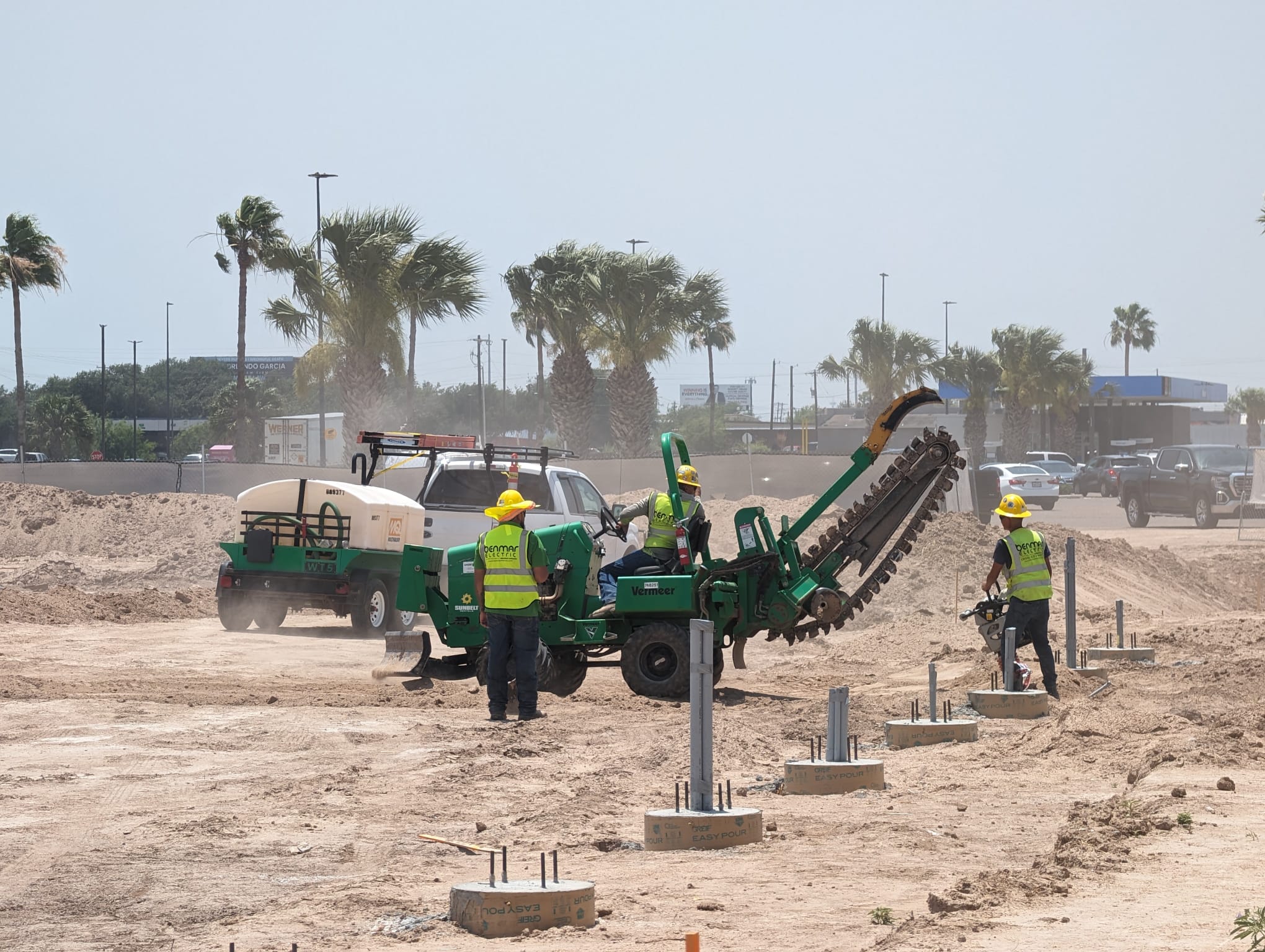 Benmar Electric crew operating Vermeer trencher on job site